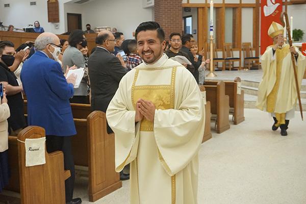Deacon Jaime Nieto smiles as he processes out of the St. Raphael sanctuary in Springdale during the closing hymn of his diaconate ordination Mass May 21. (Aprille Hanson Spivey photo)