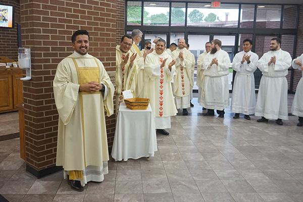 Priests, deacons and seminarians applaud Deacon Jaime Nieto following his diaconate ordination Mass May 21. (Aprille Hanson Spivey photo)