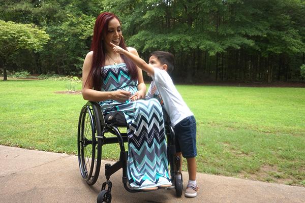 Gael Torres, 3, points to their Little Rock home while mother Ruby Varela talks with him before posing for a photo June 9. Varela passes along life lessons to her three children about safety and how to act around those with a disability. (Aprille Hanson Spivey photo)
