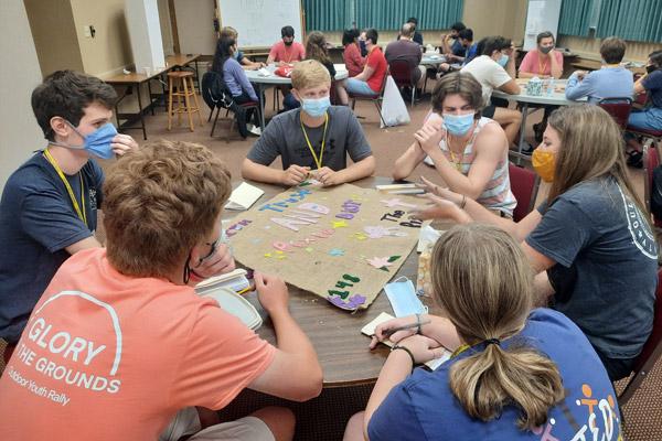 A group of retreatants, led by team member Tommy Caldarera from Christ the King Church in Fort Smith, reflect on a witness talk during Search July 17. It was the first youth retreat hosted by the diocese since December 2019. (Cole Blagg photo)
