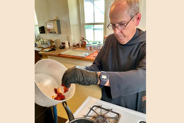 Father Richard Walz prepares a batch of Monk Sauce at Subiaco Abbey on camera June 24. The hot pepper sauce comes in three varieties, red, green and now a smoked red formula. (Courtesy Arkansas PBS)