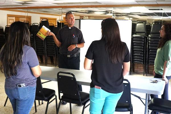 Father Mauricio Carrasco talks with faith formation leaders Aug. 26 about the renovations needed for St. Francis Parish Center to be more functional. (Malea Hargett photo)
