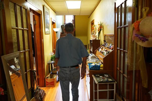 Donald Goodwin, cofounder of the St. Edward Thrift Store in Little Rock, walks down the main hallway in the old parish convent and administrative office building Sept. 13, where the store is housed. Goodwin, who is not Catholic but has volunteered for the parish for 30 years, started the store along with longtimer parishioner and his sister-in-law, LeAnn Wellinghoff, in May 2020. The store benefits the church’s operating budget. (Aprille Hanson Spivey photo) 