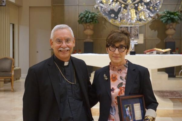 The St. Thomas More Award was given posthumously to Tim Boe, a St. Thomas More Society board member and partner at the Rose Law Firm, who died in 2020. His widow, Susan, accepted the award on his behalf from Bishop Taylor. (Chris Price photo) 
