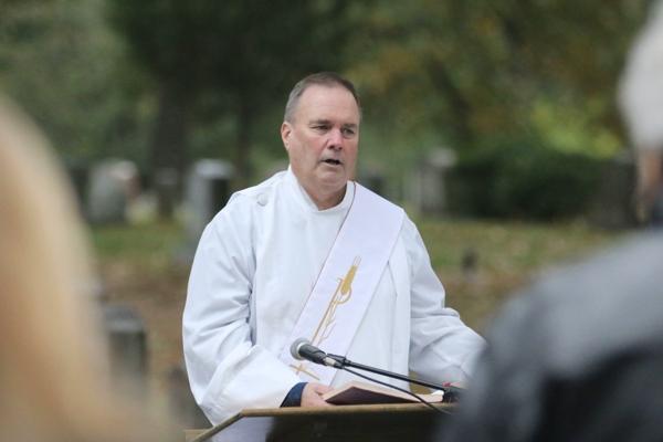 Deacon Tim Costello reads from the Gospel of John departed during the All Souls Mass at Calvary Cemetery in Little Rock Nov. 2. (Photo Chris Price)
