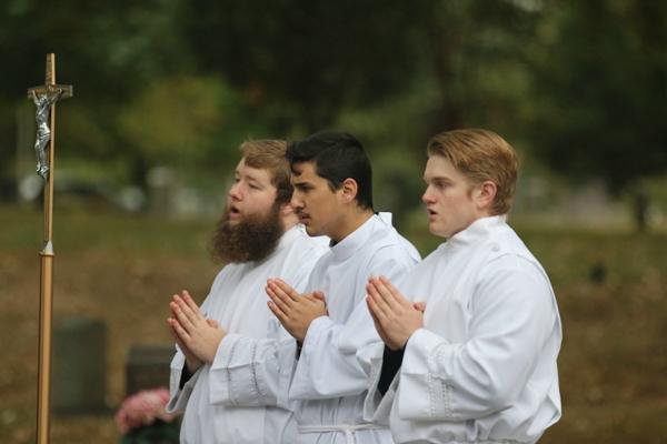 James Freeman, Pedro Alvarez and Jackson Nichols, seminarians of the House of Formation, pray during the Liturgy of the Eucharist at the All Souls Mass at Calvary Cemetery in Little Rock Nov. 2. (Photo Chris Price)
