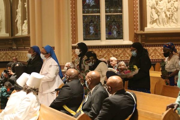 Presentation of the gifts, including fruits and other food, led by Sister Mary Francis Amanfo, DDL, Sister Chidaalu Ononiwu, DDL, and the Igbo and Nigerian Community from St. Augustine, St. Bartholomew and Our Lady of Good counsel parishes during the 35th Annual Dr. Martin Luther King Jr. Memorial Mass at the Cathedral of St. Andrew, Saturday, Jan. 15. (Chris Price photo)