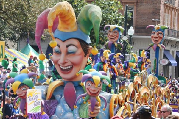 The King’s Jesters, outfitted in Mardi Gras’ traditional colors - purple for justice, green for faith and gold for power, follow Rex on his annual route. (Chris Price photo) 