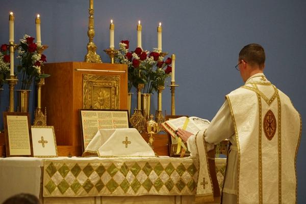 Father Jared McCambridge, FSSP, pastor of St. John the Baptist Church in Cabot, leads the Tridentine-rite Mass following the dedication of the parish's new sanctuary by Bishop Anthony B. Taylor, March 19. The parish relocated to a former Christian church at 602 E. Main Street to allow a larger congregation to attend Masses.