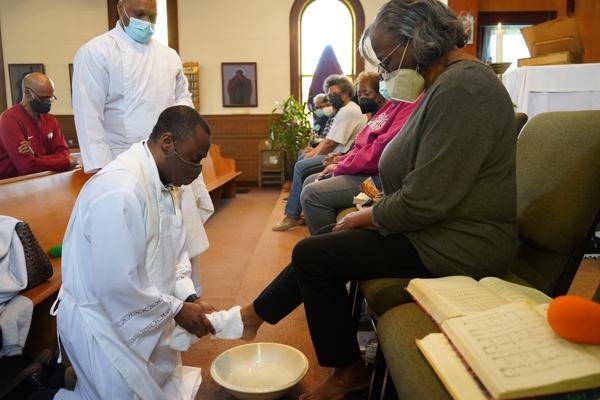 Father Leon W. Ngandu, SVD, pastor of St. Bartholomew Church in Little Rock, washes the feet of parishioner Wondrue Johnson during the parish’s Holy Thursday liturgy April 14. Aprille Hanson Spivey photo.
