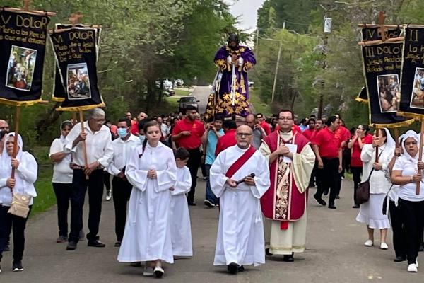 Deacon Israel Sanchez (left center) and St. Barbara Church pastor Father Ramses Mendieta lead the Penitential Way of the Cross on the streets of DeQueen on Good Friday, April 15. Parishioners carried life-size statues of Jesus the Nazarene and the Mother of Sorrows. Photo courtesy St. Barbara Church.
