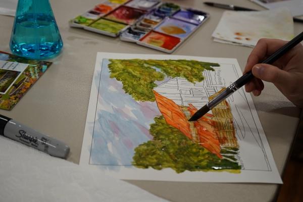 One of 15 participants in the “Paint, Paper & Prayer: Awaken Your Inner Artist” workshop at St. Joseph Church in Conway paints on a pre-drawn image of a barn April 30. 

