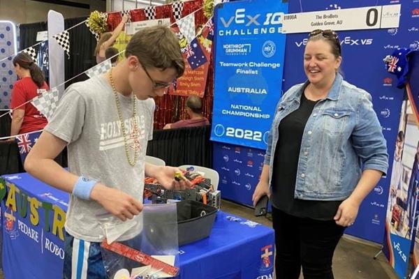 Holy Souls Robotics Team member George Saer visits a team from Australia at the VEX Robotics World Championship in Dallas, May 3-5. The competition featured 688 teams from 49 states, three Native American nations and 27 countries. (Photo courtesy Holy Souls School)