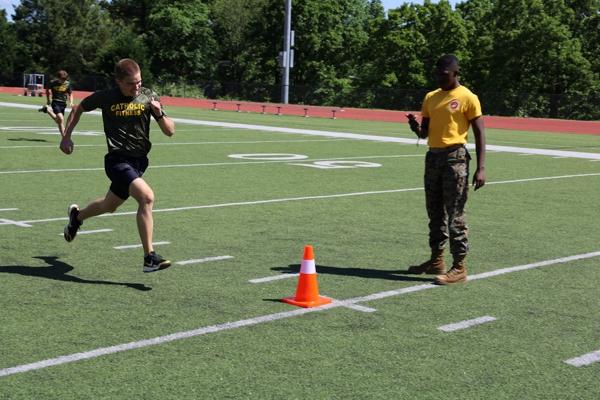 The competition involves five basic exercises — crunches, pushups, standing broad jump, chinups and a 300-yard shuttle run — with scores awarded on time (shuttle run), distance (broad jump) or number of completed exercises in a specified time.