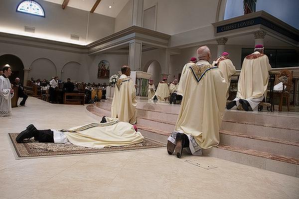 Bishop-elect Erik T. Pohlmeier lays prostrate before the Lord during his ordination as the 11th bishop of the Diocese of St. Augustine (Fla.), July 22. 