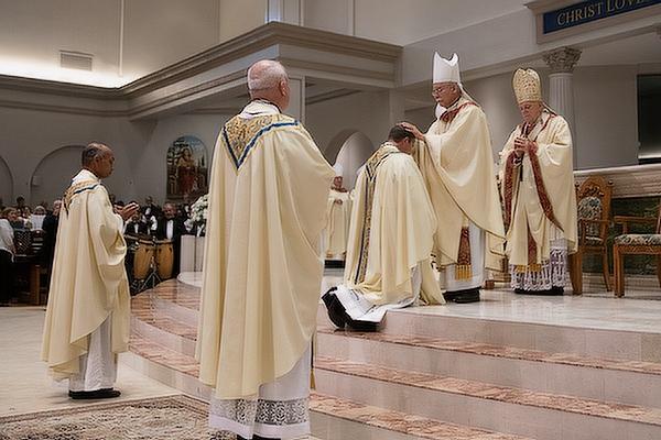 Bishop Anthony B. Taylor imposes hands on Bishop-elect Erik T. Pohlmeier's head and calls down the Holy Spirit upon him. 