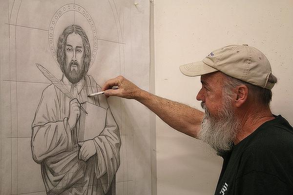 Lynn Fitzgerald, a design artist and glass painter at Soos Stained Glass in North Little Rock, puts finishing touches on a hand-drawn rendering of St. Mark for a window at Hope Lutheran Church in Jacksonville Sept. 20. Chris Price photo.