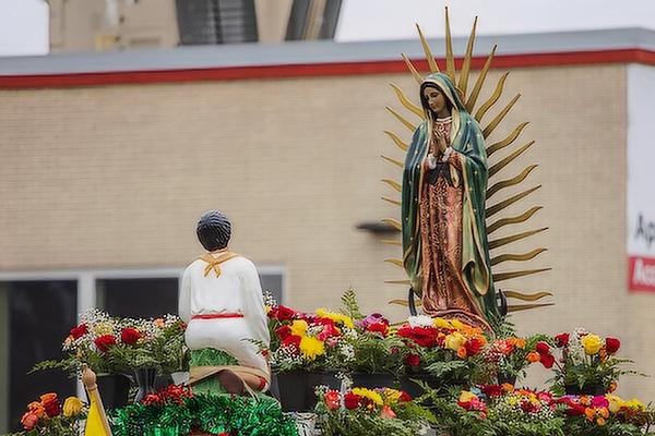 Statues of St. Juan Diego and Our Lady of Guadalupe surrounded by roses led the three mile procession of members of St. Raphael Church in Springdale Sunday, Dec. 11 to celebrate the feast of Our Lady of Guadualupe. (Travis McAfee)