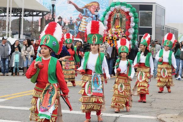 Members of the La Danza San Jose dance group process in downtown Conway Dec. 11 to celebrate the feast of Our Lady of Guadalupe. (Courtesy St. Joseph School) 