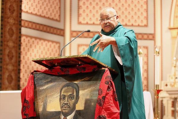 Father Warren Harvey, the bishop’s liaison for the Diocesan Council for Black Catholics, decorated the lectern with a portrait of Dr. Martin Luther King Jr. that was painted by retired diocesan priest Father Edwin Graves, 82. (Chris Price photo) 