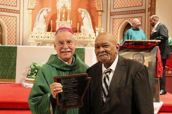 Bishop Anthony B. Taylor presents Arthur Martin with the 2023 Daniel Rudd Award at the 36th Annual Dr. Martin Luther King Jr. Memorial Mass at the Cathedral of St. Andrew, Saturday, Jan. 14. (Chris Price photo)