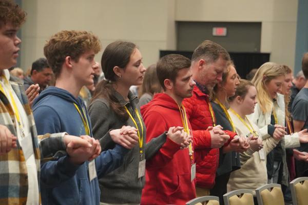 Members of the youth group at St. Agnes Church in Mena and their chaperones join hands to pray the Lord's Prayer during the annual Mass for Life in the Wally Allen Ballroom at the Statehouse Convention Center in Little Rock Jan. 22. (Malea Hargett photo)  