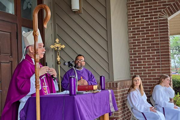 Bishop Anthony B. Taylor celebrates an outdoor Mass April 4 at St. Peter Church in Wynne following a March 31 tornado that destroyed parts of the city. The church was not damaged in the storm. (Courtesy Catholic Charities of Arkansas)