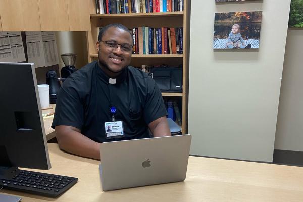 Duwan Booker, a seminarian for the Diocese of Little Rock, works on his schedule before visiting patients July 13. The 11-week Clinical Pastoral Education program at Baptist Health Medical Center in Little Rock covers training required for all seminarians. (Courtesy Baptist Health)
