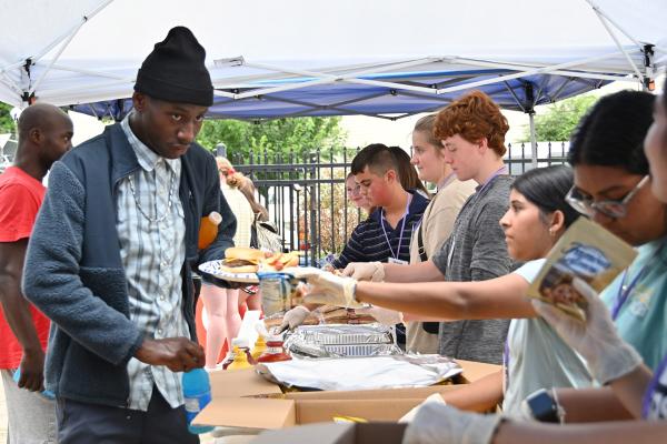C2SI participants distribute food during a cookout at Jericho Way in Little Rock July 11. (Collin Gallimore photo)
