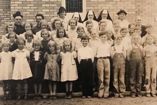 This class photo from 1935 at St. Anthony School was taken in front of St. Anthony Church in Weiner. Among parishioners and school children are Father Otto Butterbach (1938-1947), Sister Selesai, Sister Jerome, and Sister Paula. Courtesy Jeannie Sitzer.