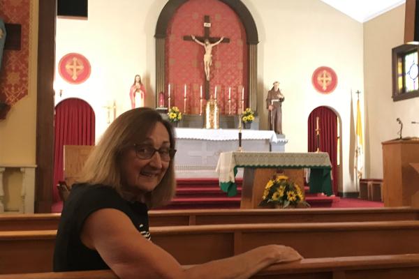 Dr. Jeannie Sitzer sits inside St. Anthony Church in Weiner, founded in 1906 and rebuilt after fires in 1931 and 1936, was recently added to the state’s Historical Register. Photo by Jeannie Sitzer. 