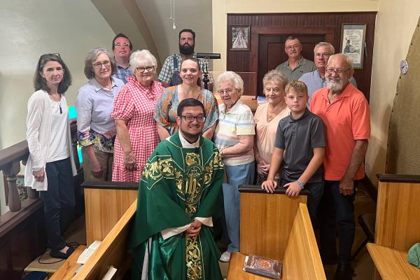 Members of the choir at St. John the Baptist Church in Engelberg gather around Father Stephen Elser after performing at Mass Aug. 20. Courtesy Jane Smith.