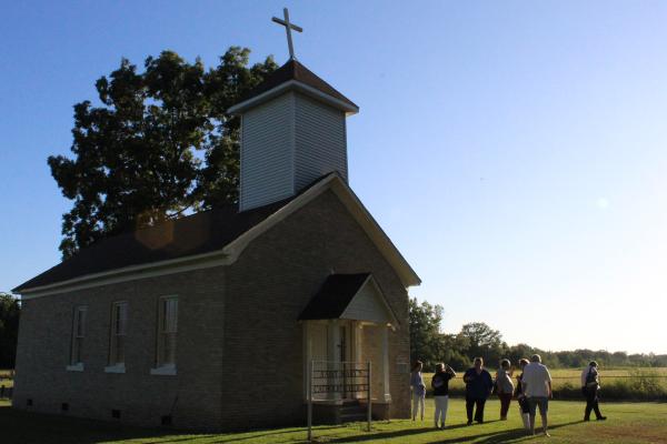 Catholics around Jefferson County catch up following monthly Mass Aug. 31 outside St. Mary Church in Plum Bayou, the oldest Catholic church in Arkansas. Photo by Chandler Bartel.