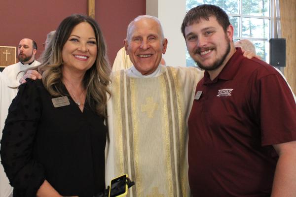 (Left to right) Campus Minister Tachia Awbrey, Deacon Richard Papini and Assistant Campus Minister Luke Hoelzeman stand near the altar of the new Catholic campus ministry building in Conway. Katie Zakrzewski.