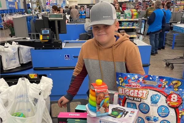 Eli Paladino stands with the toys he purchased for his toy drive fundraiser Nov. 24  before delivering them to Arkansas Children's Hospital. 