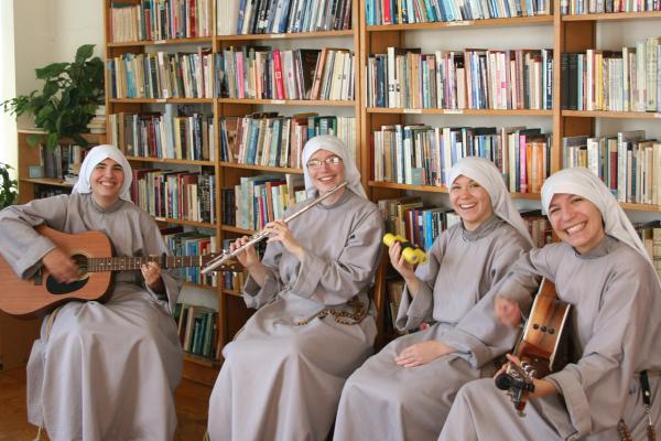 Sister Magdalene Marie of the Good Shepherd (left), formerly Madison Moseley of Christ the King Church in Little Rock, plays guitar with her fellow novices from the Convent of San Damiano in The Bronx in September. Sister Magdalene will spend two years as a novice, discerning before consecration to religious life. CFR Sisters.