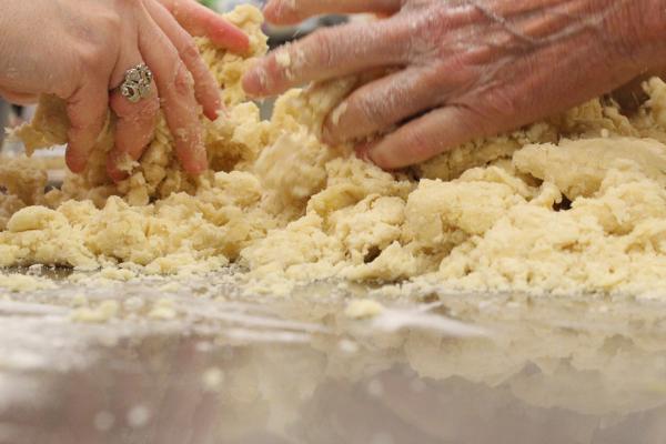 Italian club members mix and knead the dough before cutting and rolling it into various shapes before baking at the Christ the King Family Life Center in Little Rock March 2. (Katie Zakrzewski)