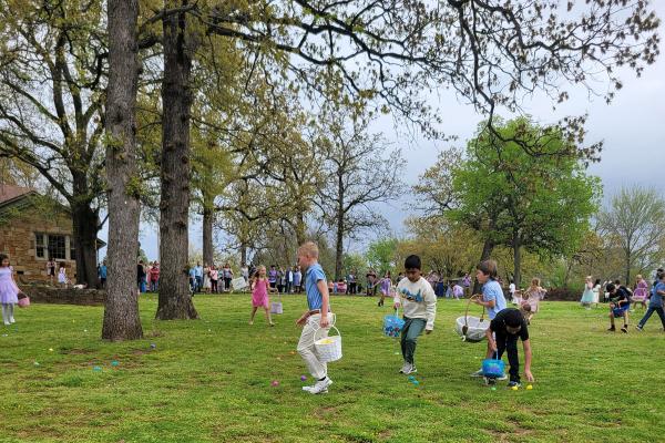 Children run across the lawn during an Easter egg hunt March 31. (Alesia Schaefer).