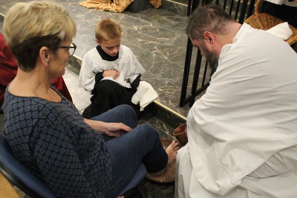 Father Luke Womack (photo above), pastor of Our Lady of Fatima Church in Benton, washes a parishioner’s feet during the Holy Thursday Mass March 28. (Katie Zakrzewski)