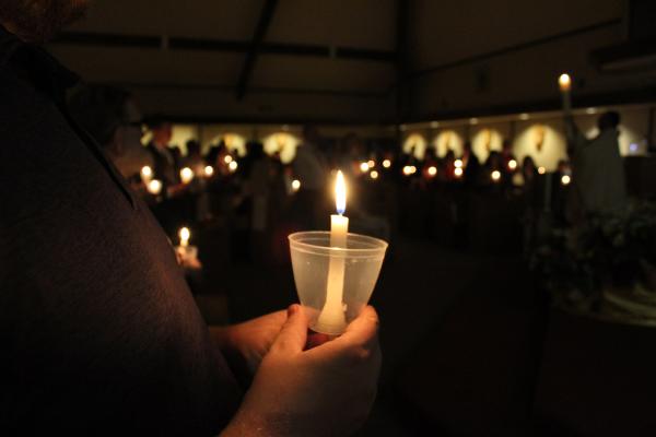 Parishioners at St. Jude the Apostle Church in Jacksonville are surrounded by candlelight during the processional hymn of the Easter vigil Mass March 31. (Katie Zakrzewski)
