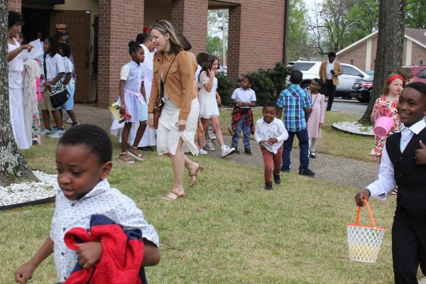 Children run across the lawn during the Easter egg hunt at St. Augustine Church in North Little Rock March 31. (Katie Zakrzewski)