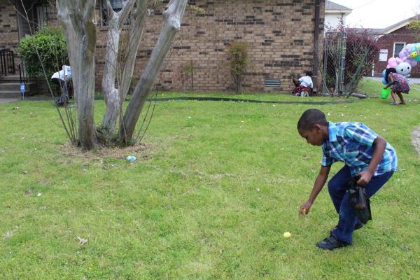 A young boy reaches for an Easter egg on the lawn at St. Augustine Church in North Little Rock during the Easter egg hunt following Easter Mass March 31. (Katie Zakrzewski)
