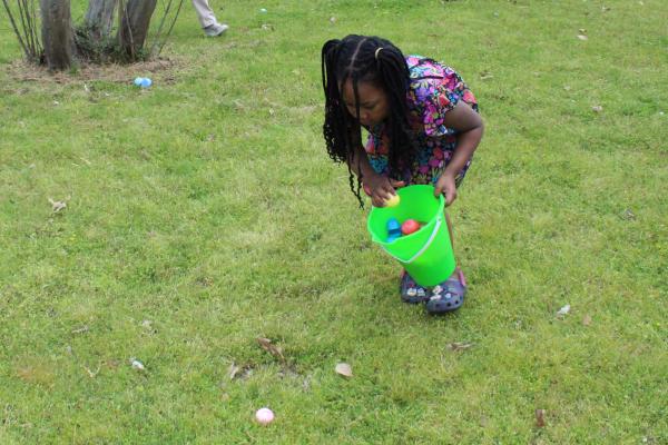 A little girl adds another Easter egg to her basket during the Easter egg hunt at St. Augustine Church in North Little Rock March 31.