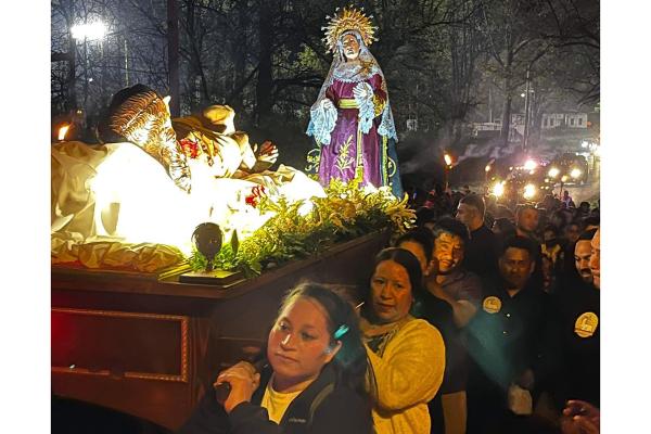 As night falls, parishioners at St. Barbara Church in De Queen march through the streets during a Good Friday procession carrying a display of Jesus and the Virgin Mary. (Courtesy Father Father Ramsés Mendieta)